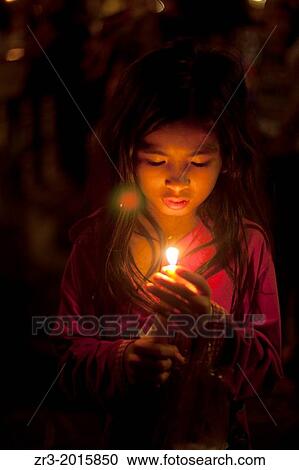 A young Cambodian girl prays at a small shrine next to the Mekong River in Phnom Penh, Cambodia. View Large Photo Image Stock Image - A young Cambodian girl prays at a small shrine next to the Mekong River in Phnom Penh, Cambodia.. Fotosearch