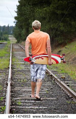 A young, caucasian male with a longboard skateboard View Large Photo Image Stock Image - A young, caucasian male with a longboard skateboard. Fotosearch