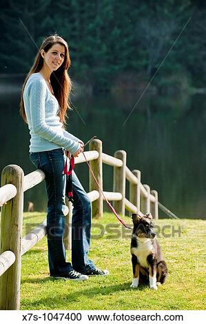 A young Caucasian woman and her puppy dog at the park View Large Photo Image Stock Image - A young Caucasian woman and her puppy dog at the park. Fotosearch
