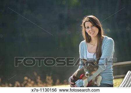 A young Caucasian woman and her puppy dog at the park View Large Photo Image Stock Photograph - A young Caucasian woman and her puppy dog at the park. Fotosearch