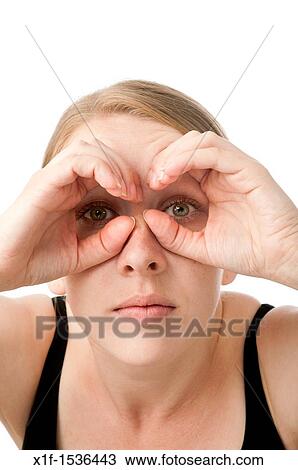 a young caucasian woman looking through her hands shaped like binoculars, uk View Large Photo Image Stock Image - a young caucasian woman looking through her hands shaped like binoculars, uk. Fotosearch