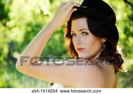A young caucasian woman outdoors in a park View Large Photo Image Picture - A young caucasian woman outdoors in a park. Fotosearch