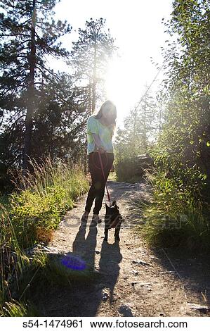 A young caucasian woman outdoors with her dog on Tubbs Hill, Coeur d? Alene, Idaho, USA. View Large Photo Image Stock Image - A young caucasian woman outdoors with her dog on Tubbs Hill, Coeur d? Alene, Idaho, USA.. Fotosearch