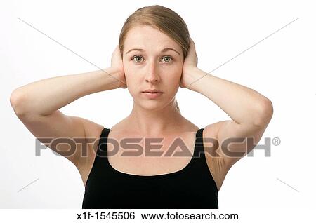 a young caucasian woman with her hands over her ears keeping out sound - hear no evil View Large Photo Image Stock Photograph - a young caucasian woman with her hands over her ears keeping out sound - hear no evil. Fotosearch