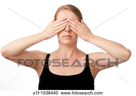 a young caucasian woman with her hjands over her eyes see no evil View Large Photo Image Stock Image - a young caucasian woman with her hjands over her eyes see no evil. Fotosearch