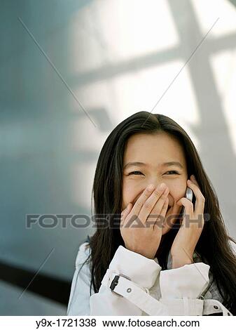 A young Chinese business woman using her mobile phone PDA in the city View Large Photo Image Stock Photo - A young Chinese business woman using her mobile phone PDA in the city. Fotosearch