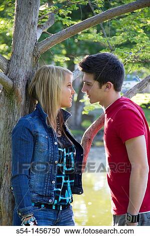 A young couple at the park View Large Photo Image Stock Image - A young couple at the park. Fotosearch
