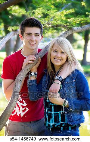 A young couple at the park View Large Photo Image Stock Photo - A young couple at the park. Fotosearch