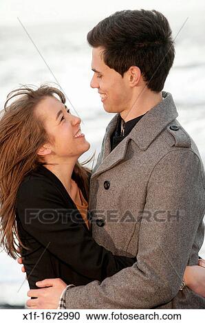 A young couple, boyfriend and girlfriend, together on a windy afternoon on the seashore, west wales UK View Large Photo Image Stock Image - A young couple, boyfriend and girlfriend, together on a windy afternoon on the seashore, west wales UK. Fotosearch