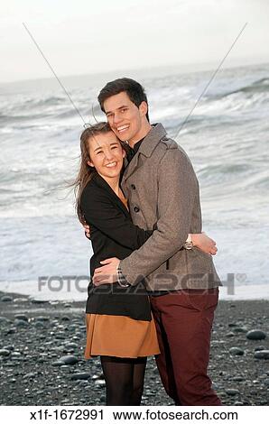 A young couple, boyfriend and girlfriend, together on a windy afternoon on the seashore, west wales UK View Large Photo Image Stock Image - A young couple, boyfriend and girlfriend, together on a windy afternoon on the seashore, west wales UK. Fotosearch