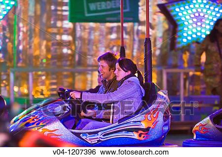 A young couple driving around in a bumper car at the Bremen Annual Fair, Bremen, Germany, Europe View Large Photo Image Stock Photograph - A young couple driving around in a bumper car at the Bremen Annual Fair, Bremen, Germany, Europe. Fotosearch
