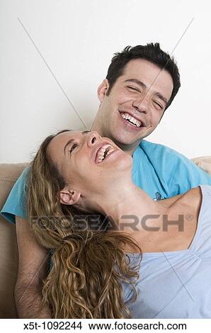 Picture - A young couple in their 20s enjoying an intimate moment. Fotosearch