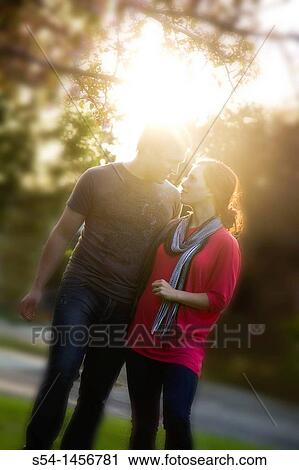 A young couple outdoors in the park. View Large Photo Image Stock Image - A young couple outdoors in the park.. Fotosearch