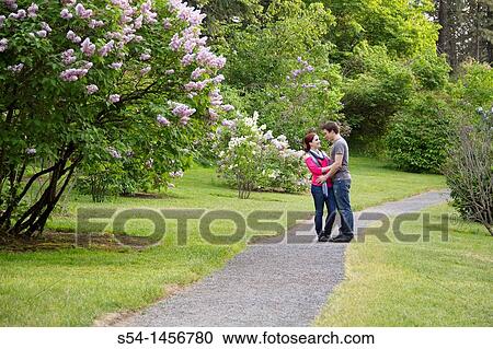 A young couple outdoors View Large Photo Image Stock Image - A young couple outdoors. Fotosearch