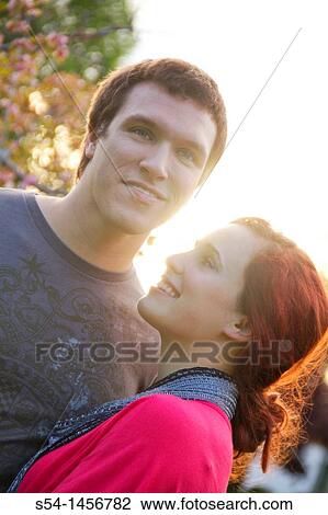 A young couple outdoors View Large Photo Image Stock Image - A young couple outdoors. Fotosearch