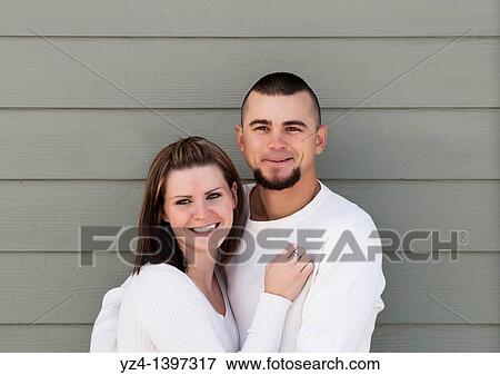 A young couple outdoors View Large Photo Image Stock Photo - A young couple outdoors. Fotosearch