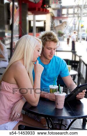A young couple together at a coffee shop in Spokane, Washington, USA. View Large Photo Image Stock Image - A young couple together at a coffee shop in Spokane, Washington, USA.. Fotosearch