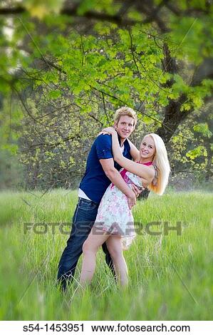 A young couple together in a park View Large Photo Image Stock Image - A young couple together in a park. Fotosearch