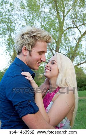 A young couple together in a park View Large Photo Image Stock Image - A young couple together in a park. Fotosearch