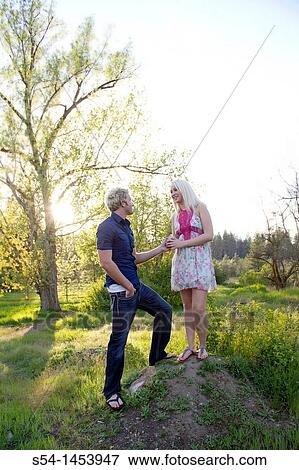 Stock Photo - A young couple together in a park. Fotosearch