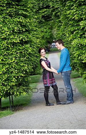 A young couple walking together at a park in Washington State, USA. View Large Photo Image Picture - A young couple walking together at a park in Washington State, USA.. Fotosearch