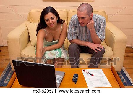 A young couple working together at home. View Large Photo Image Stock Image - A young couple working together at home.. Fotosearch