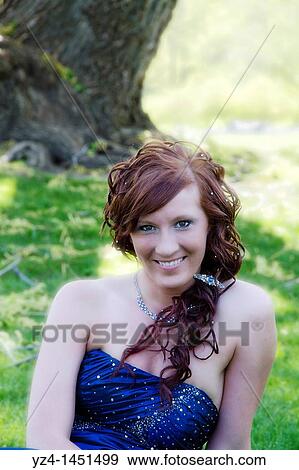 A young female high school student in a prom dress outdoors. View Large Photo Image Stock Photo - A young female high school student in a prom dress outdoors.. Fotosearch