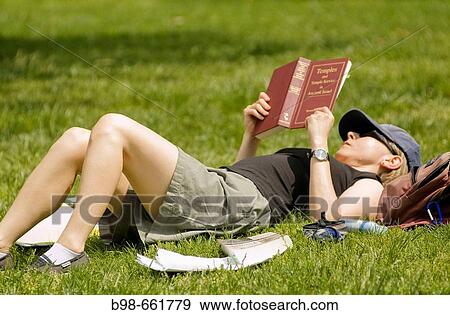 Stock Photo - A young female student reads on campus at Catholic University, Washington, DC. Fotosearch