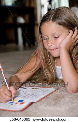 a young girl does her homework. age 5_7yrs. View Large Photo Image Stock Photography - a young girl does her homework. age 5_7yrs.. Fotosearch