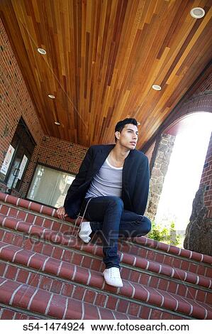 Picture - A young hispanic male outdoors near a shopping center in Spokane, Washington, USA.. Fotosearch