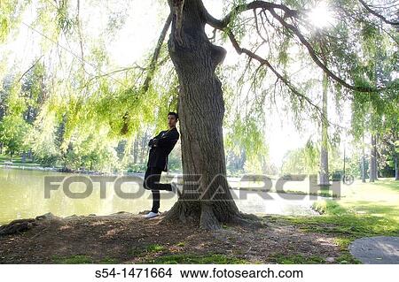 A young hispanic male outdoors. View Large Photo Image Picture - A young hispanic male outdoors.. Fotosearch