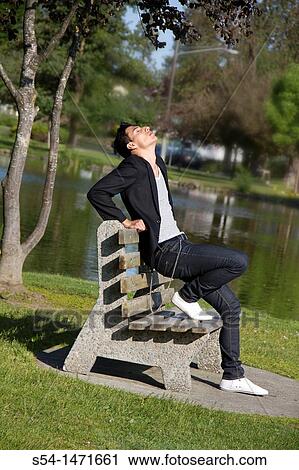 Stock Image - A young hispanic male outdoors.. Fotosearch