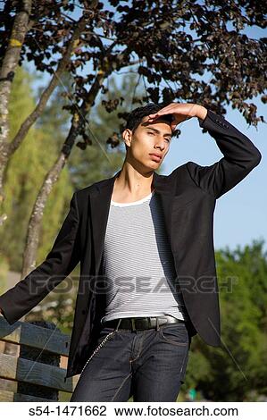 A young hispanic male outdoors. View Large Photo Image Stock Image - A young hispanic male outdoors.. Fotosearch