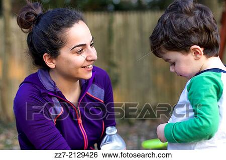 A young Iranian woman talks to her son. View Large Photo Image Stock Photograph - A young Iranian woman talks to her son.. Fotosearch