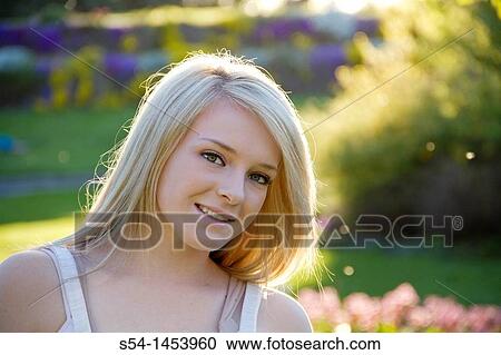A young lady in a park View Large Photo Image Stock Image - A young lady in a park. Fotosearch