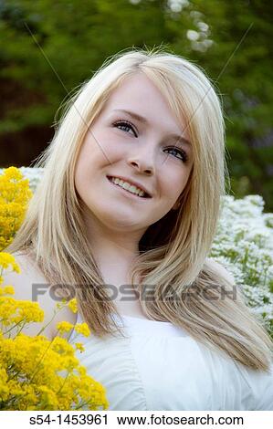 Stock Image - A young lady in a park. Fotosearch
