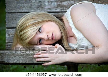 A young lady in a park View Large Photo Image Stock Photo - A young lady in a park. Fotosearch