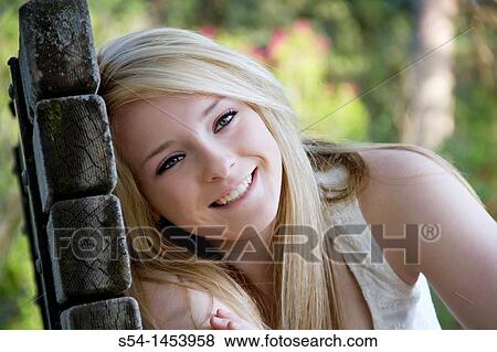 A young lady in a park View Large Photo Image Stock Photo - A young lady in a park. Fotosearch