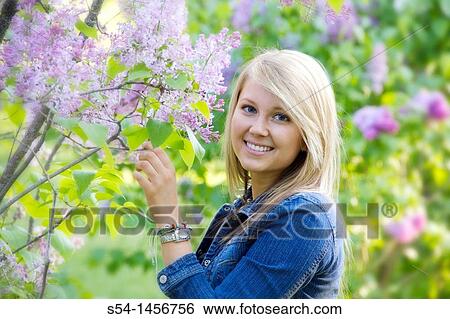 Stock Photograph - A young lady outdoors. Fotosearch