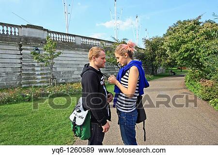 Stock Photo - A young man and a woman in love having a chat.. Fotosearch