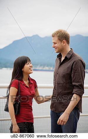A young man and woman laughing together, Vancouver, British Columbia, Canada View Large Photo Image Stock Image - A young man and woman laughing together, Vancouver, British Columbia, Canada. Fotosearch
