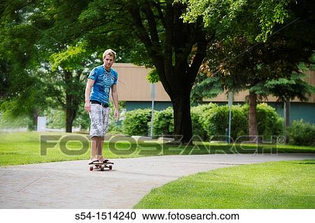 A young man longboarding in Coeur d? Alene, Idaho, USA View Large Photo Image Stock Image - A young man longboarding in Coeur d? Alene, Idaho, USA. Fotosearch