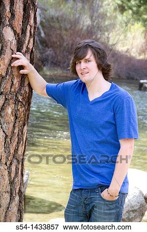 A young man outdoors View Large Photo Image Stock Photo - A young man outdoors. Fotosearch