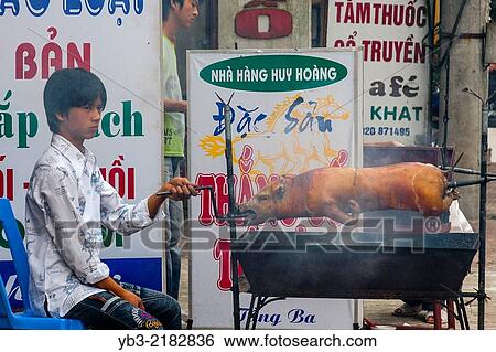 A Young Man Roasting A Pig, Sa Pa, Lao Cai Province, Vietnam. View Large Photo Image Stock Photograph - A Young Man Roasting A Pig, Sa Pa, Lao Cai Province, Vietnam.. Fotosearch