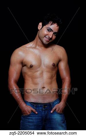 A young man showing his physique, Pune, India. View Large Photo Image Picture - A young man showing his physique, Pune, India.. Fotosearch