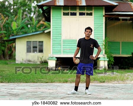 A young man standing and holding a rattan ball that is used in the sport Sepak takraw, a type of kick volleyball native to the Malay-Thai Peninsula View Large Photo Image Stock Image - A young man standing and holding a rattan ball that is used in the sport Sepak takraw, a type of kick volleyball native to the Malay-Thai Peninsula. Fotosearch