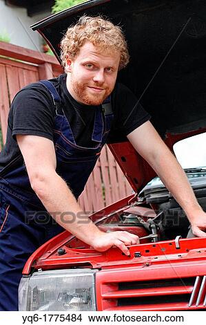 A young mechanic repairing the old car, portrait View Large Photo Image Picture - A young mechanic repairing the old car, portrait. Fotosearch