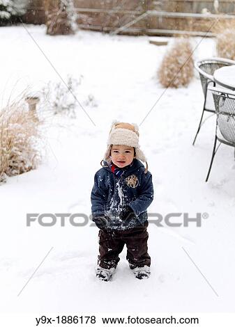 A young mixed ethnicity child playing in the snow View Large Photo Image Stock Photo - A young mixed ethnicity child playing in the snow. Fotosearch