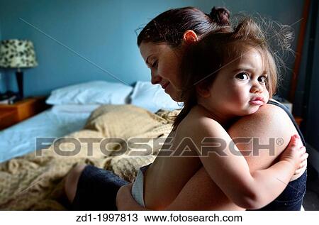 A young mother carries her baby on her arms. View Large Photo Image Stock Image - A young mother carries her baby on her arms.. Fotosearch