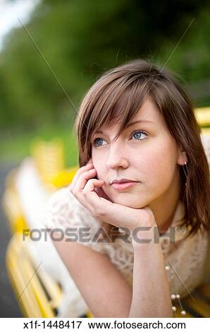 A young slim attractive girl in her late teens or early 20's thinking, looking pensive thoughtful, UK View Large Photo Image Stock Photo - A young slim attractive girl in her late teens or early 20's thinking, looking pensive thoughtful, UK. Fotosearch